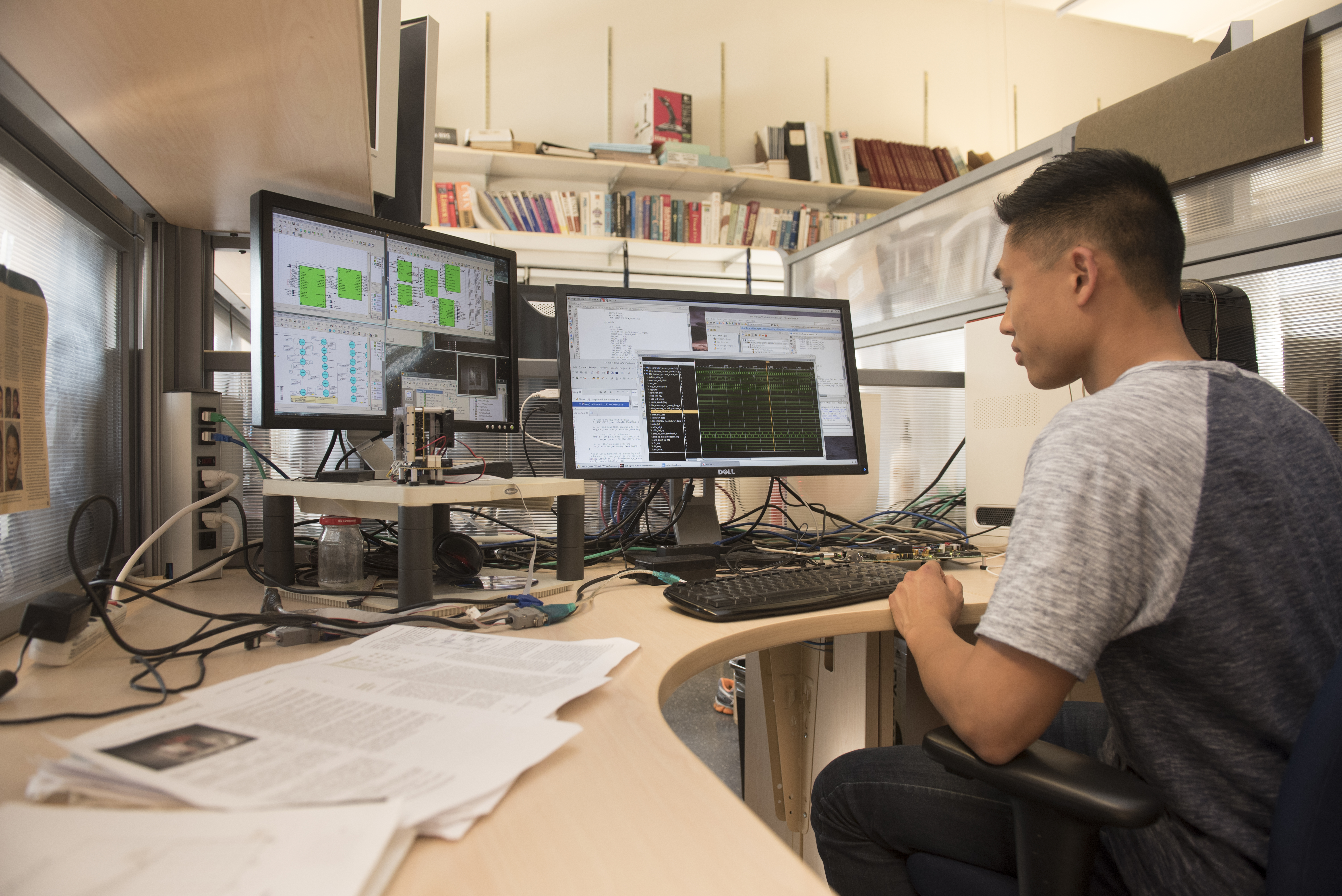 Student studying data on computer screens